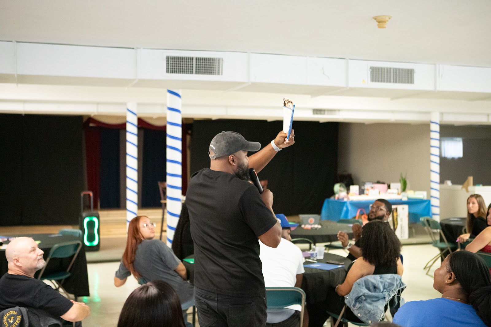 Neil Ray speaking into a microphone during a training