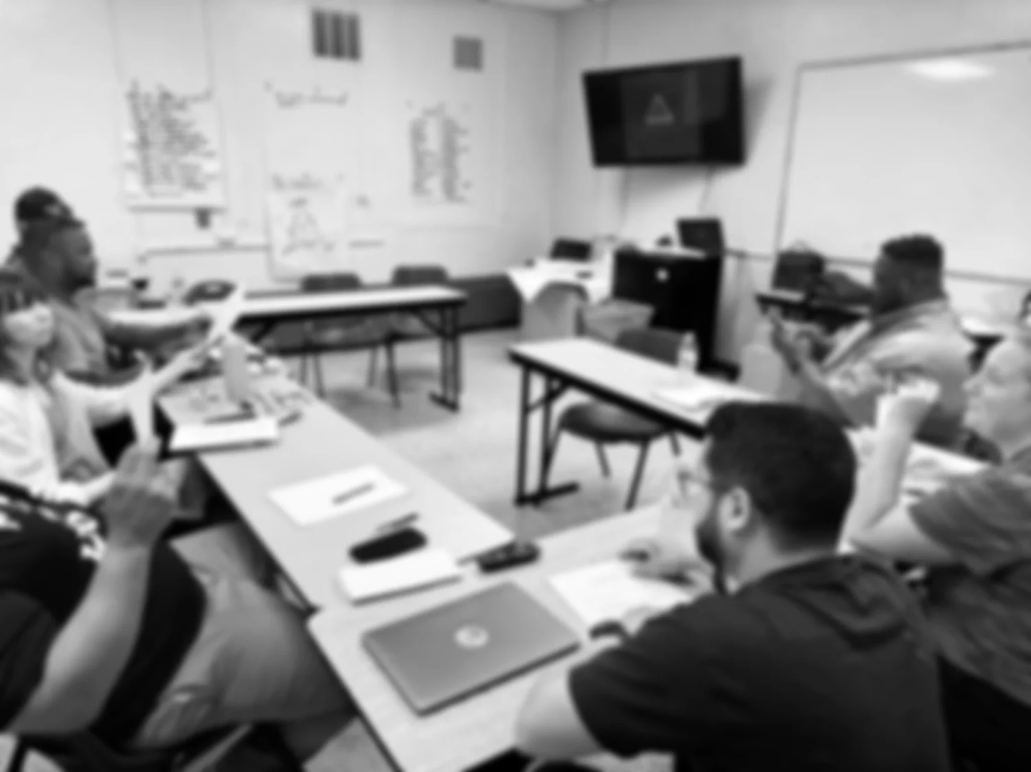 Educators around tables during a Re-Approach training session
